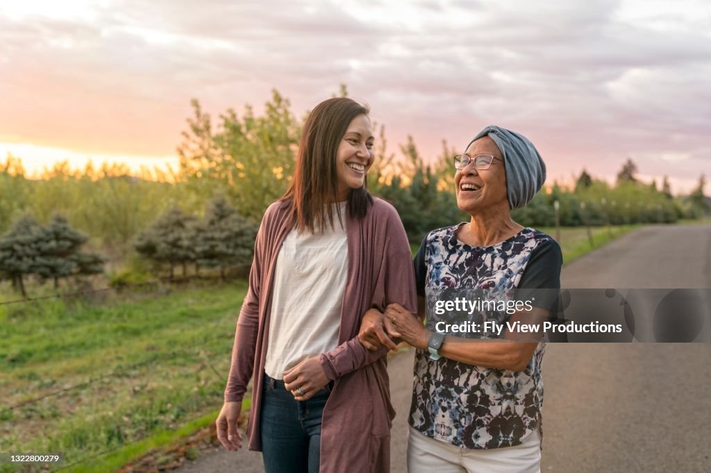 Beautiful mixed race mother and daughter relaxing outdoors together