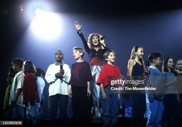 Celine Dion and a local choir perform at San Jose Arena on October 14, 1998 in San Jose, California.