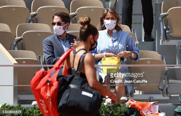 Pregnant Ophelie Meunier and husband Mathieu Vergne applaud Maria Sakkari of Greece during day 11 of the 2021 Roland-Garros, French Open, a Grand...