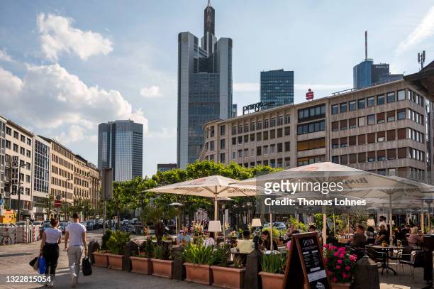 The headquarters of Commerzbank is seen as people walk along a street in the financial district on June 09, 2021 in Frankfurt, Germany. While the...