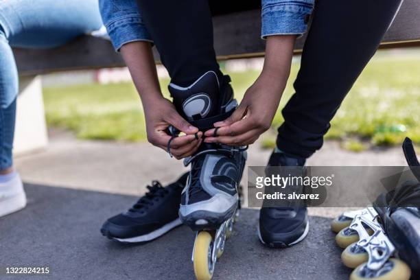 close-up of a woman putting on roller skates - inline skate 個照片及圖片檔