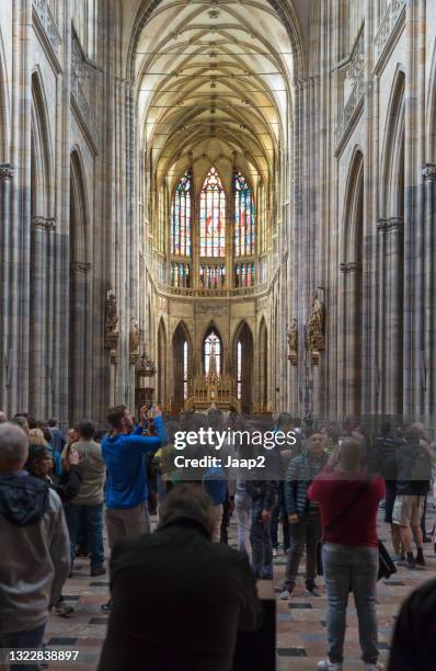 tourists admiring the interior of the st. vitus cathedral in prague - cathedral of st vitus stock pictures, royalty-free photos & images