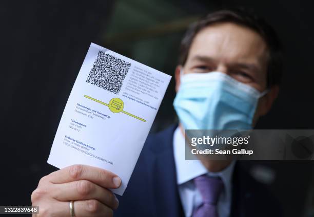 Ronald Fritz, CovPass project manager at IBM, shows QR code on the European Union Covid-19 vaccination certificate that can be used to activate the...