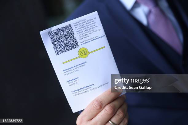 Ronald Fritz, CovPass project manager at IBM, shows QR code on the European Union Covid-19 vaccination certificate that can be used to activate the...