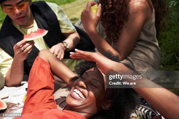 friends relaxing during a summer picnic - fun relax stock-fotos und bilder