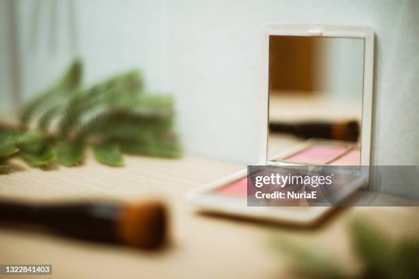 close-up of a cosmetics palette and make-up brush on a table - vanity table stock pictures, royalty-free photos & images