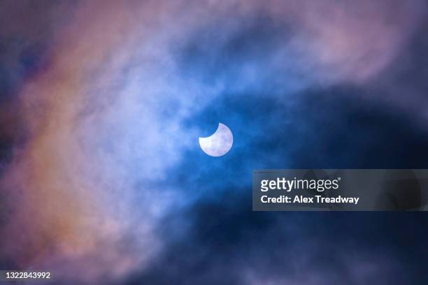 a partial solar eclipse seen from great malvern in the uk - moody sky moon night stock pictures, royalty-free photos & images