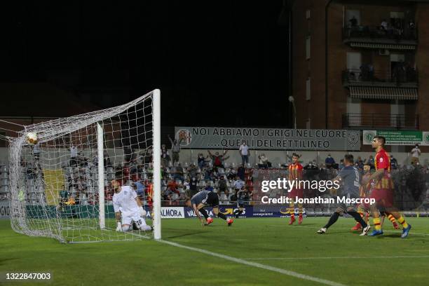 Francesco Stanco of US Alessandria heads the ball past Alberto Savini of UC Albinoleffe to level the score on the night and give the side a 4-3...