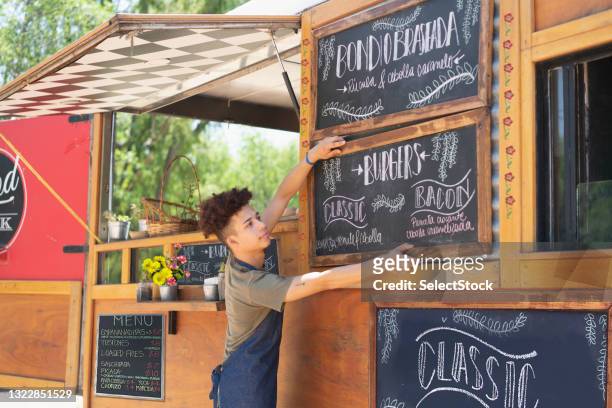 young man working in a food truck - argentina food imagens e fotografias de stock