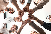 Portrait of diverse business people giving fist bump in cirle