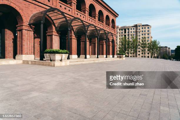 city square in front of modern buildings - block paving stockfoto's en -beelden