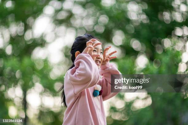 little girl arms raised flying - tiger girl stock pictures, royalty-free photos & images