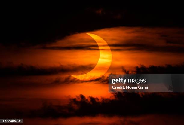 The sun rises over New York City during a solar eclipse on June 10, 2021 as seen from The Edge observatory deck at The Hudson Yards. Northeast states...