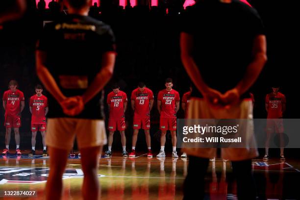 Players observe a minutes silence during game one of the NBL Semi-Final Series between the Perth Wildcats and the Illawarra Hawks at RAC Arena, on...