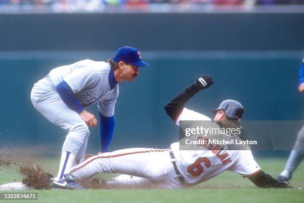 Dickie Thon of the Texas Rangers tags out Joe Orsulak of the Baltimore Orioles during a baseball game on July 26, 1992 at Oriole Park at Camden Yards...