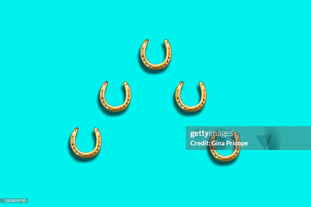 Five gold colored horseshoes