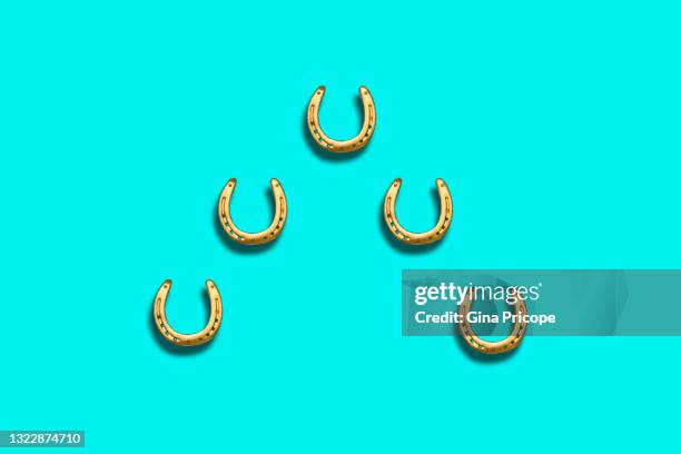 five gold colored horseshoes - horseshoe isolated stock pictures, royalty-free photos & images