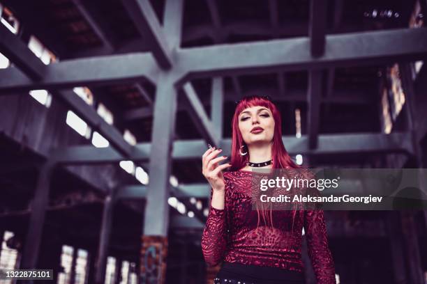 cigarette time for beautiful gothic redhead female - metalhead stock pictures, royalty-free photos & images