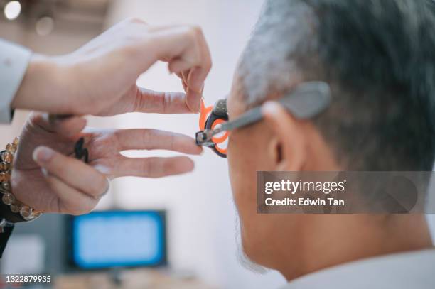 asian chinese senior man patient checking eyesight in ophthalmological clinic - eye chart stock pictures, royalty-free photos & images