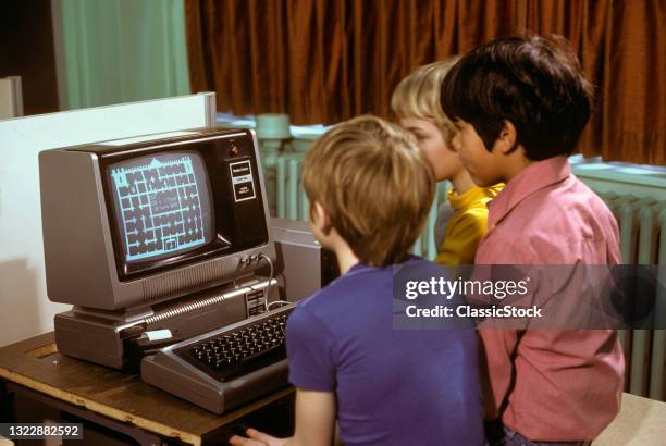 1980s three Elementary School Boys Operating Early Radio Shack Trs80 Computer.