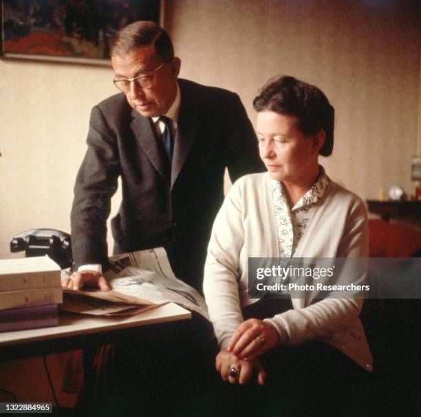 French authors and philosophers Jean-Paul Sartre and Simone de Beauvoir in Sartre's apartment on the Rue Bonaparte, Paris, France, circa 1964.