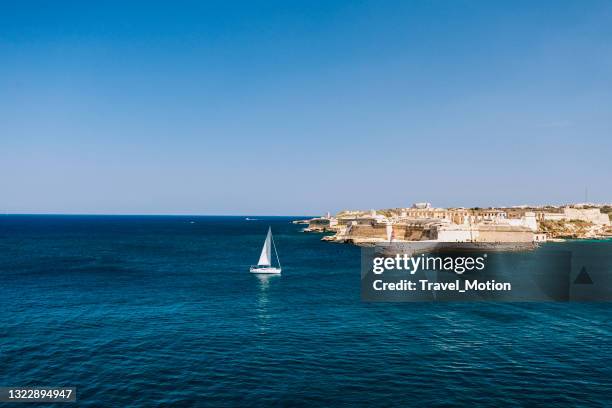 sailboat at valletta bay, malta - malta harbour stock pictures, royalty-free photos & images