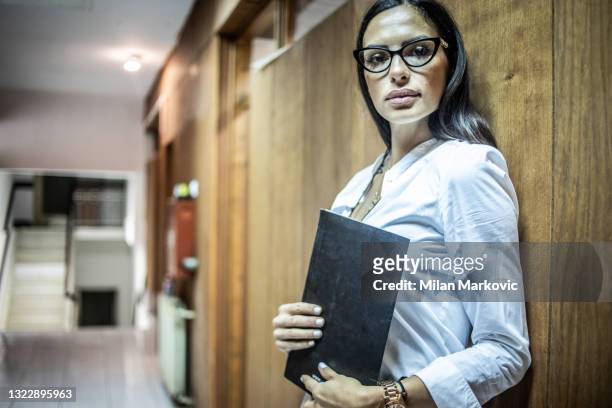 hard work of a detective in the office - female police inspector. - fbi files stock pictures, royalty-free photos & images