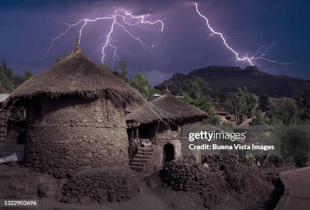 thunderstorm over african village - lightning home stock pictures, royalty-free photos & images