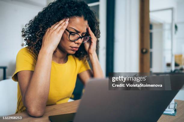 stressed woman using laptop in the office. - zoom fatigue stock pictures, royalty-free photos & images