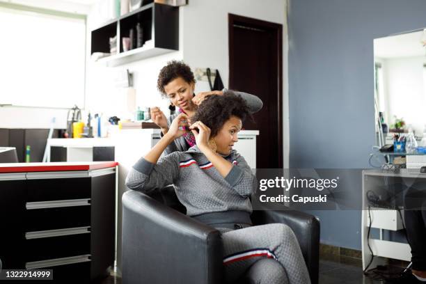 friends styling each other's hair at the salon - black hair stylist stock pictures, royalty-free photos & images