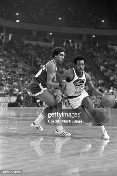 Denver Nuggets guard Jim Price drives past Seattle Supersonics guard Dennis Johnson during an NBA basketball game at McNichols Arena on January 21,...