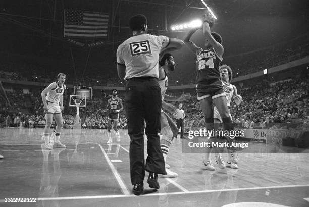 Seattle Supersonics guard Dennis Johnson shoots over Denver Nuggets forward Willie Wise during an NBA basketball game at McNichols Arena on January...