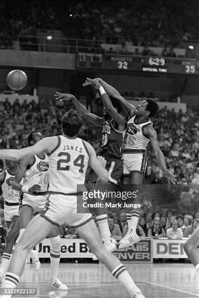 Denver Nuggets guard Jim Price blocks a shot by Seattle Supersonics forward Bob Wilkerson during an NBA basketball game at McNichols Arena on January...