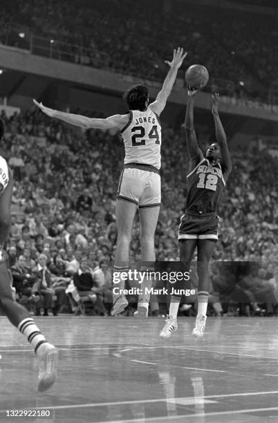 Seattle Supersonics forward Nick Weatherspoon attempts a jumper over defending Denver Nuggets forward Bobby Jones during an NBA basketball game at...