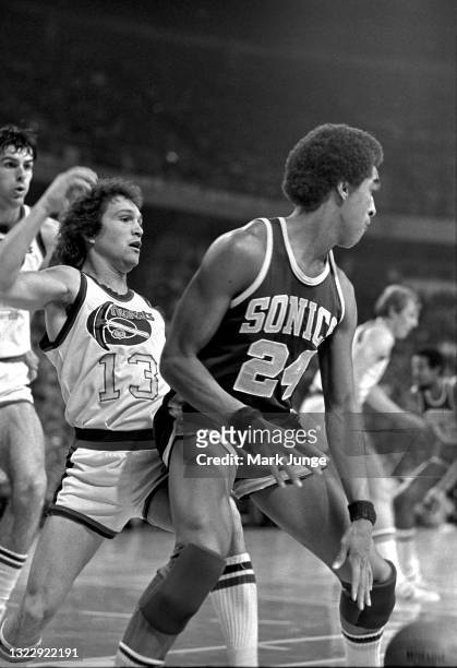 Denver Nuggets guard Monte Towe blocks Seattle Supersonics guard Dennis Johnson during an NBA basketball game at McNichols Arena on January 21, 1977...