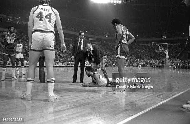 Denver Nuggets Head Trainer Robert “Chopper” Travaglini leans down to examine an injured Nuggets forward Willie Wise $42 during an NBA basketball...