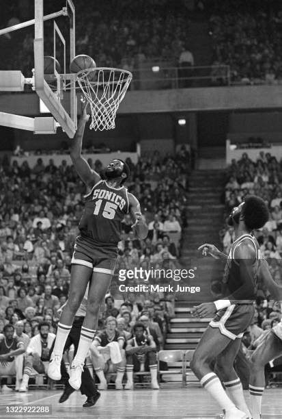 Seattle Supersonics forward Willie Norwood puts up a layup as teammate Bob Wilkerson watches during an NBA basketball game against the Denver Nuggets...