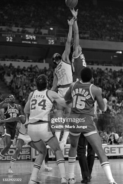 Seattle Supersonics guard Dennis Johnson competes with Denver Nuggets forward Willie Wise in a tipoff during an NBA basketball game at McNichols...