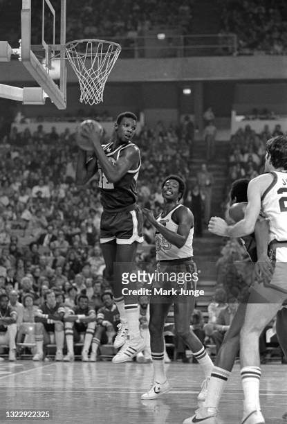 Seattle Supersonics forward Nick Weatherspoon grabs a rebound in front of Denver Nuggets forward Paul Silas during an NBA basketball game at...