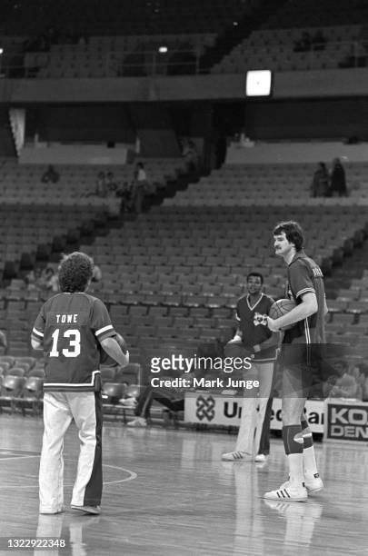 Denver Nuggets 5’7” guard Monte Towe talks with 7’1” teammate Marvin Webster and 7’2” Seattle Supersonics center Tom Burleson during the pre-game...