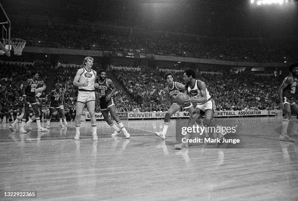Denver Nuggets guard Jim Price tries to throw the ball past Seattle Supersonics guard Dennis Johnson during an NBA basketball game against at...
