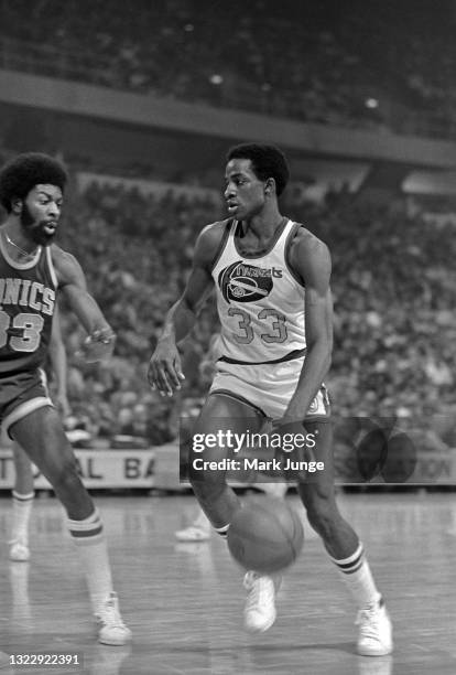 Denver Nuggets forward David Thompson dribbles past Seattle Supersonics forward Bob Wilkerson during an NBA basketball game at McNichols Arena on...