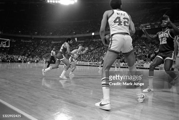 Denver Nuggets forward Willie Wise prepares to pass the ball to a breaking teammate Monte Towe during a timeout in an NBA basketball game against the...