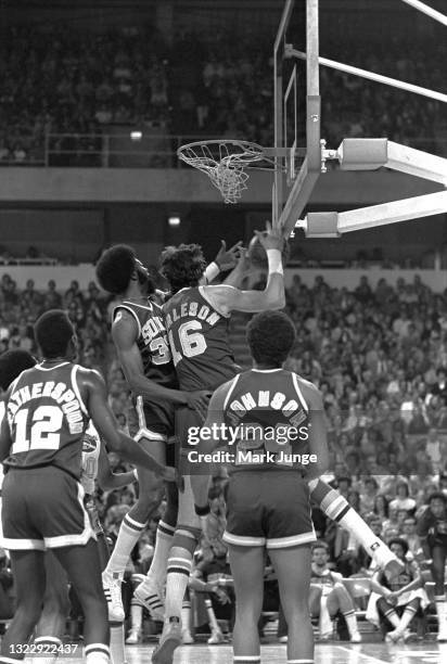 Seattle Supersonics forward Bob Wilkerson and center Tom Burleson go up for a rebound during an NBA basketball game against the Denver Nuggets at...