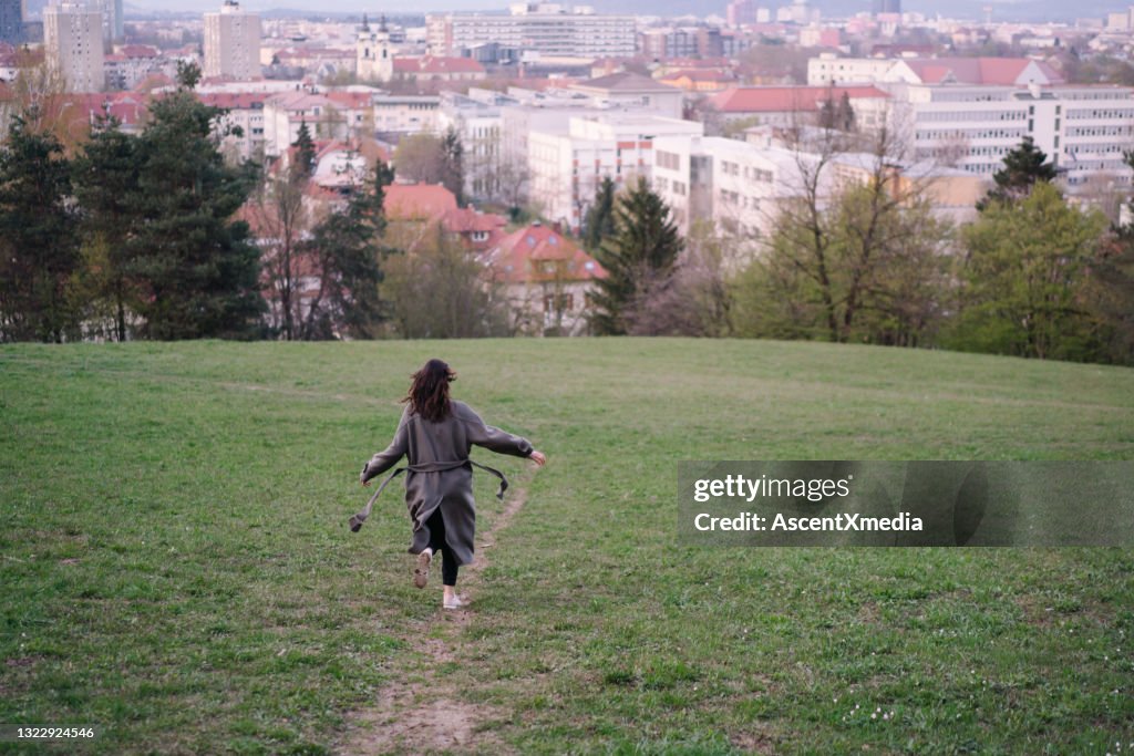 Young runs and dances through city park