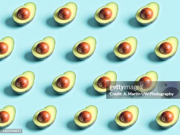 avocado pattern isolated on a blue background - avocado stock pictures, royalty-free photos & images