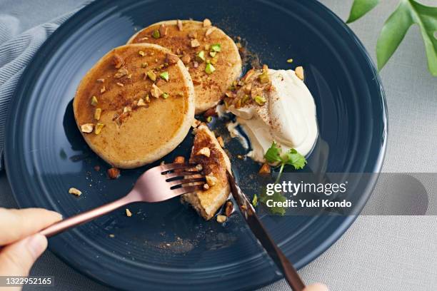 eat pancakes with a fork and knife. - serving size stock pictures, royalty-free photos & images