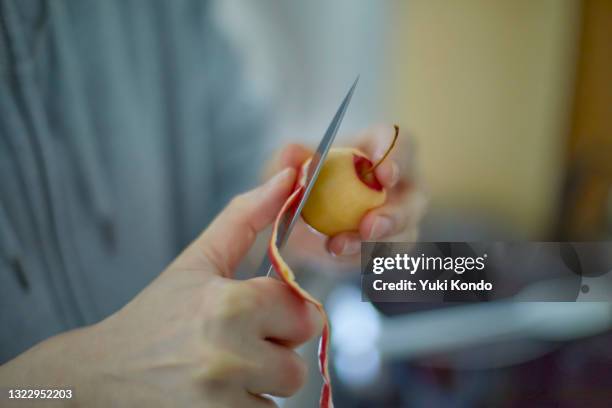 peel the apple. - peeled stock pictures, royalty-free photos & images