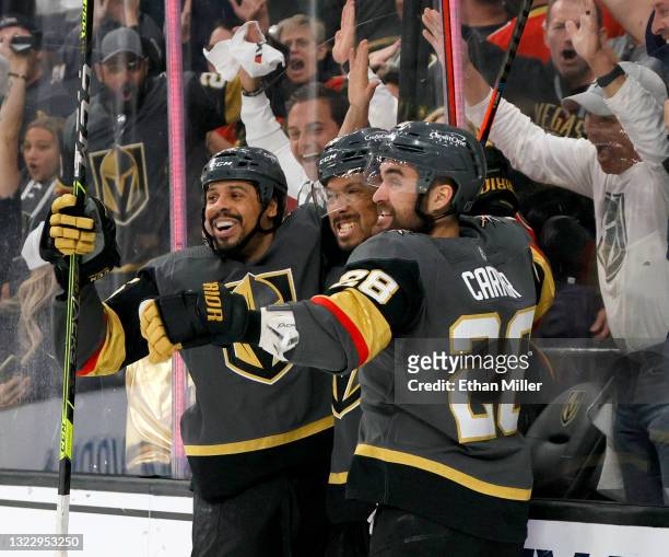 Ryan Reaves, Keegan Kolesar and William Carrier of the Vegas Golden Knights celebrate Kolesar's second-period goal against the Colorado Avalanche in...