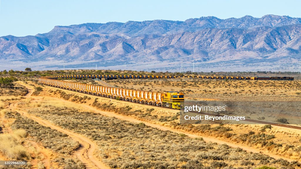 Long loaded iron ore train with Flinders Ranges background